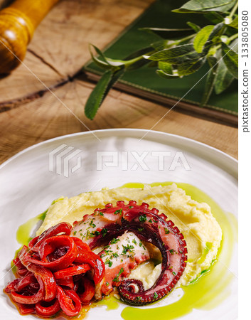 Delicious octopus dish with mashed potatoes and pepper sauce served elegantly 133805080