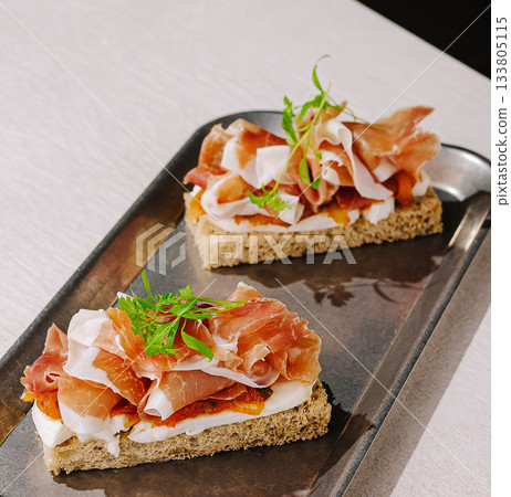 Delicious open-faced sandwiches with cured meat and fresh toppings 133805115
