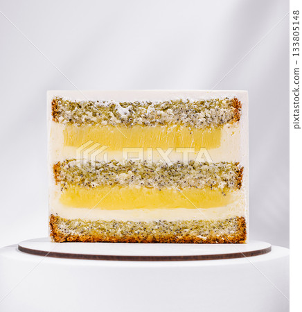 Delicious layered cake with lemon filling and poppy seeds in bright setting 133805148
