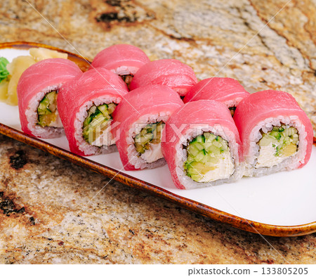 Fresh sushi rolls served on a platter at a restaurant in the evening Fresh sushi rolls served on a platter at a restaurant in the evening 133805205