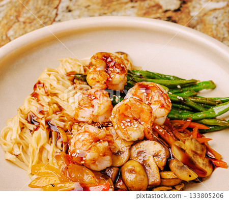 Shrimp stir fry with noodles and vegetables served in a bowl Shrimp stir fry with noodles and vegetables served in a bowl 133805206