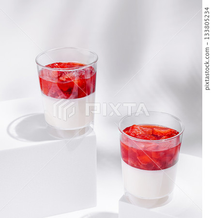 Delicious strawberry dessert served in clear cups on a white background Delicious strawberry dessert served in clear cups on a white background 133805234
