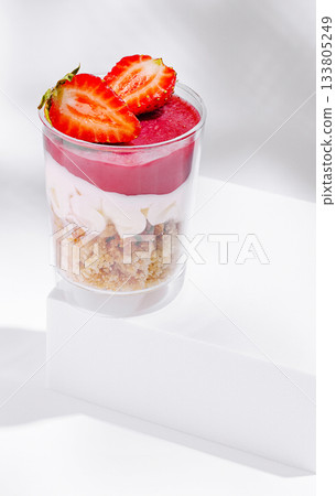 Fresh strawberry dessert in a clear cup with smooth layers and vibrant colors Fresh strawberry dessert in a clear cup with smooth layers and vibrant colors 133805249