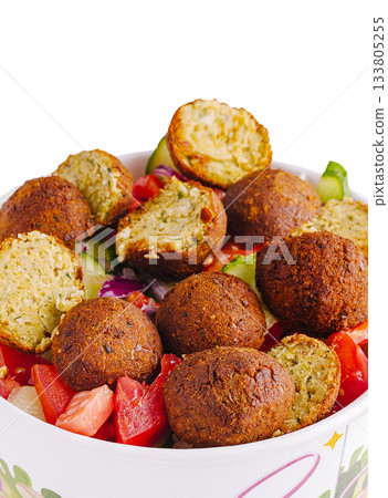Fresh falafel salad with assorted vegetables and herbs served in a bowl Fresh falafel salad with assorted vegetables and herbs served in a bowl 133805255