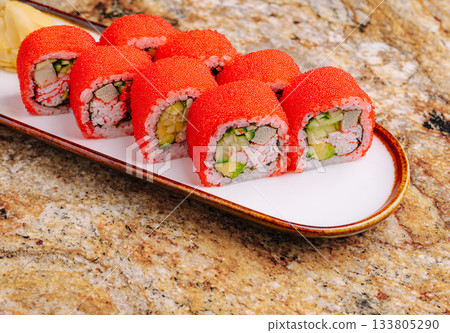 Vibrant sushi rolls on a platter with fresh ingredients 133805290