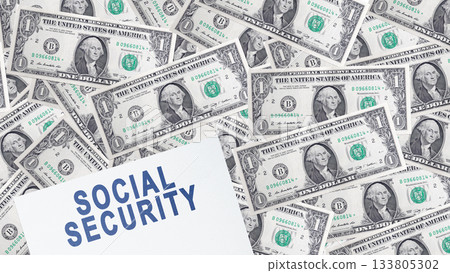 Flat lay of Social Security text on white paper with United States dollar bills background. Concept of social security 133805302