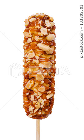 Delicious caramel-coated corn dog dessert on a stick with nuts Delicious caramel-coated corn dog dessert on a stick with nuts 133805303