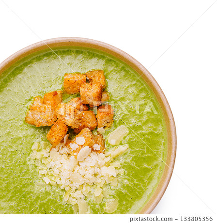 Fresh green soup topped with croutons and garnishes in a bowl Fresh green soup topped with croutons and garnishes in a bowl 133805356
