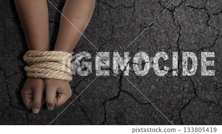 Hands tied together with rope against a cracked background. Representing the atrocity of genocide and human rights violations. Concept of Genocide Hands tied together with rope against a cracked background. Representing the atrocity of genocide and human rights violations. Concept of Genocide 133805419