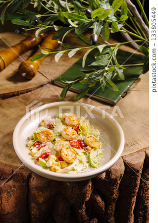 Fresh shrimp salad with vegetables served on a rustic wooden table 133805449