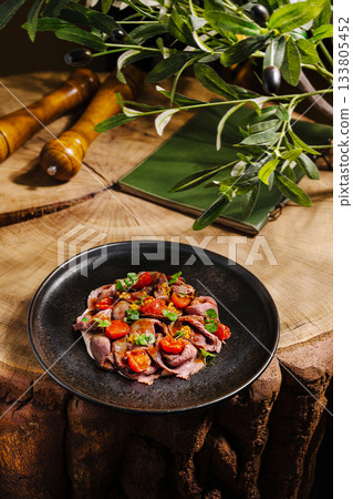 Delicious plate of meat with tomatoes served on rustic wooden table Delicious plate of meat with tomatoes served on rustic wooden table 133805452