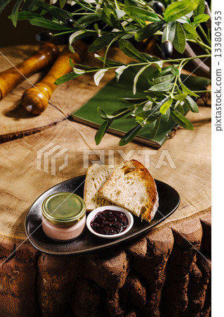 Delicious spread with bread and jam on a rustic wooden table Delicious spread with bread and jam on a rustic wooden table 133805453