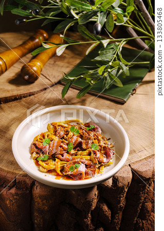 Delicious dish of tender meat with herbs served on rustic wooden table Delicious dish of tender meat with herbs served on rustic wooden table 133805468