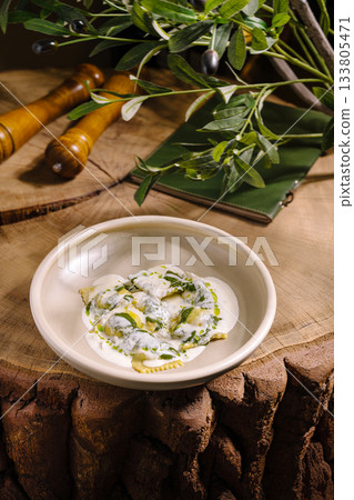 Fresh pasta with green sauce served on a rustic wooden surface 133805471