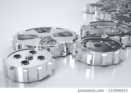 3D render is showing polished metal gears reflecting light on glossy white platform, adding depth 133806425