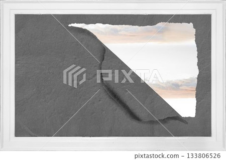 Rip on wall showing bright sky 133806526