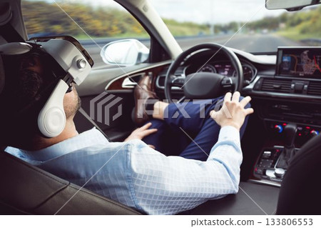 man behind the wheel wearing a virtual reality helmet 133806553