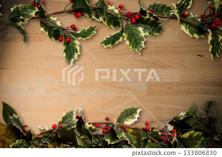 Holly twigs over wooden planks Holly twigs over wooden planks 133806830