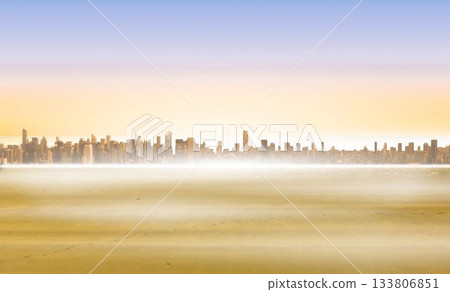Skyline of skyscrapers is glowing under sunrise in flat design, misty shoreline reflecting light 133806851