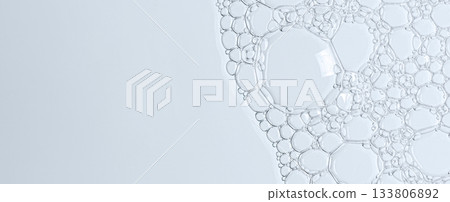 The texture of the foam of shower gel or soap suds or shaving foam. Macrophotography. Copy space 133806892
