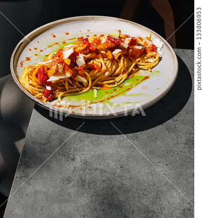 Delicious pasta dish served on a modern table in a cozy restaurant setting 133806953