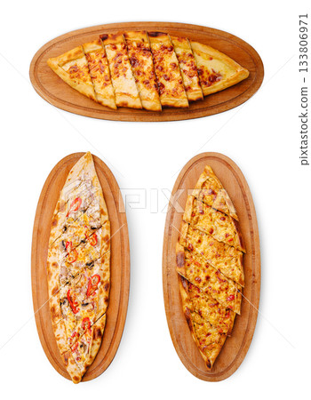 Delicious variety of Turkish pide served on wooden platters Delicious variety of Turkish pide served on wooden platters 133806971