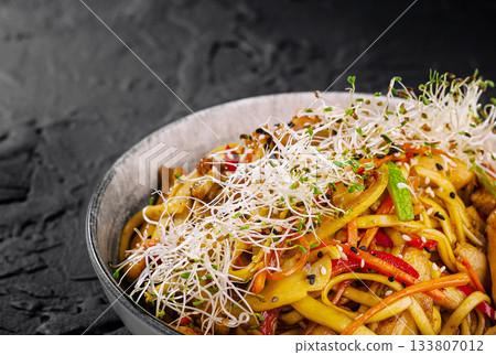 Delicious stir-fried noodles with vegetables and sprouts in a trendy bowl Delicious stir-fried noodles with vegetables and sprouts in a trendy bowl 133807012