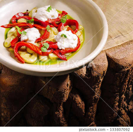 Tasty dish with red peppers, creamy topping, and fresh herbs Tasty dish with red peppers, creamy topping, and fresh herbs 133807092