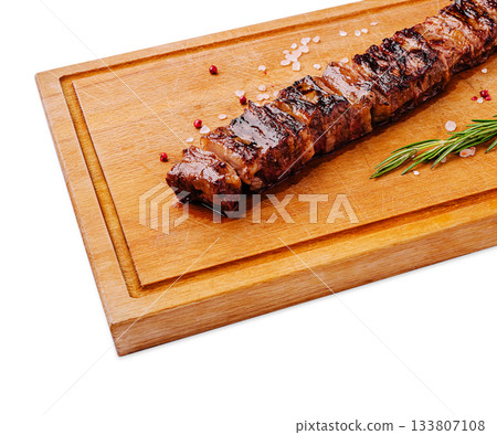 Perfectly grilled meat on a wooden board with herbs and seasoning Perfectly grilled meat on a wooden board with herbs and seasoning 133807108