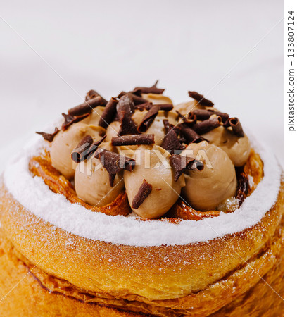 Delicious pastry topped with chocolate mousse and chocolate shavings 133807124