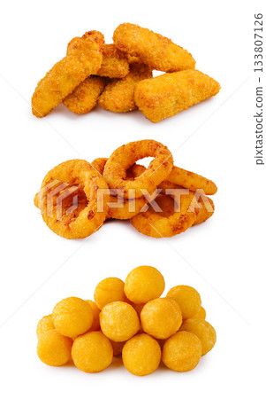 Variety of crispy fried snacks arranged in three layers for tasty enjoyment Variety of crispy fried snacks arranged in three layers for tasty enjoyment 133807126