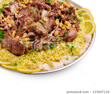 Savory dish of rice and meat with herbs and lemon slices served on a platter Savory dish of rice and meat with herbs and lemon slices served on a platter 133807128