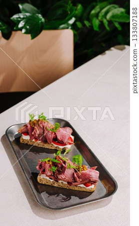 Delicious roast beef sandwiches served on a sleek tray in a modern cafe 133807188