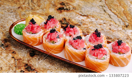 Delicious sushi platter featuring colorful rolls and fresh fish 133807223