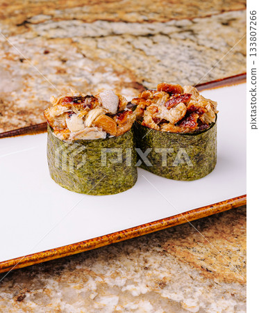 Delicious sushi rolls prepared with fresh ingredients at a sushi restaurant Delicious sushi rolls prepared with fresh ingredients at a sushi restaurant 133807266