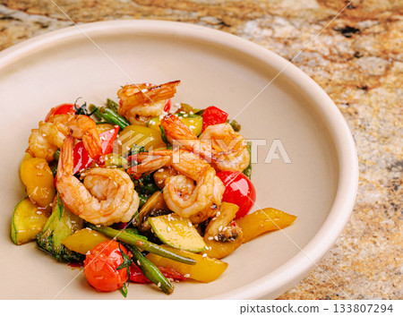 Shrimp stir-fry with fresh vegetables served in a bowl Shrimp stir-fry with fresh vegetables served in a bowl 133807294