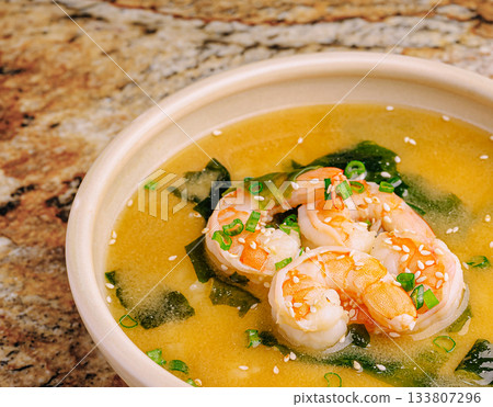 Delicious shrimp soup with seaweed served in a white bowl 133807296