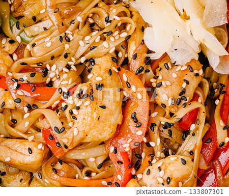 Tasty stir-fried chicken noodles with vibrant veggies in a bowl 133807301