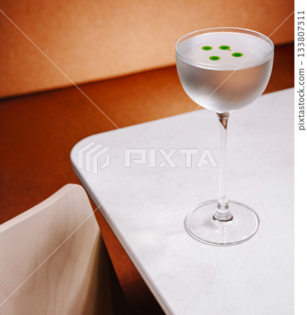 Elegant cocktail on a table with unique garnish in a modern setting 133807311