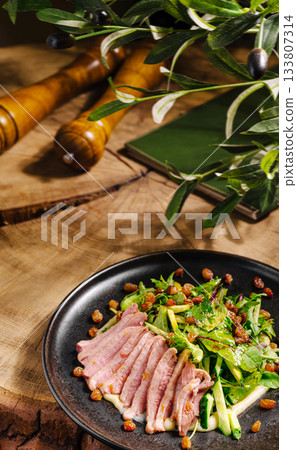 Deliciously arranged salad with sliced meat on a rustic wooden table Deliciously arranged salad with sliced meat on a rustic wooden table 133807314