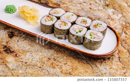 Fresh sushi rolls served on a white plate with wasabi and ginger Fresh sushi rolls served on a white plate with wasabi and ginger 133807357