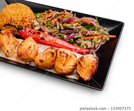 Grilled chicken platter with spicy pepper, salad, and flavorful rice Grilled chicken platter with spicy pepper, salad, and flavorful rice 133807375