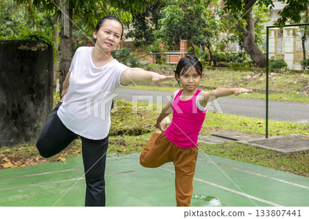 Indonesian woman and a child are practicing yoga together 133807441