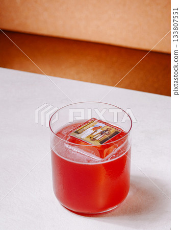 Colorful cocktail with unique ice cube on a modern table Colorful cocktail with unique ice cube on a modern table 133807551
