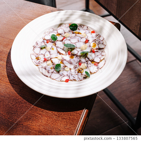 Delicious seafood dish served in a cozy restaurant setting during daytime Delicious seafood dish served in a cozy restaurant setting during daytime 133807565