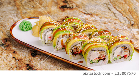 Delicious sushi rolls with colorful toppings served on a wooden plate Delicious sushi rolls with colorful toppings served on a wooden plate 133807576