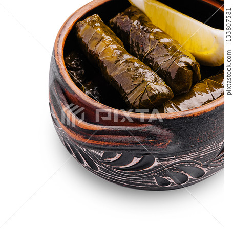 Delicious grape leaves stuffed with rice and herbs served in a traditional bowl 133807581