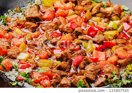 Savory colorful beef stir-fry with vegetables in a vibrant cooking setting 133807585