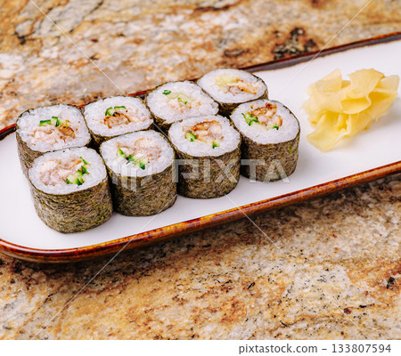 Fresh sushi rolls served on a decorative plate with ginger Fresh sushi rolls served on a decorative plate with ginger 133807594