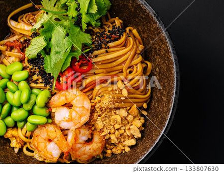 Delicious shrimp and vegetable stir-fry with noodles in a bowl 133807630